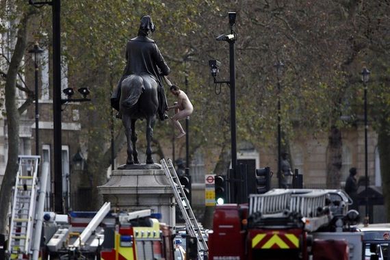 naked-man-sits-on-statue-in-central-london