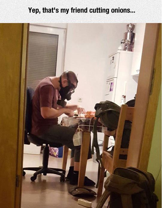 funny-man-cutting-onions-mask-gas-kitchen