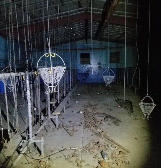 Abandoned room with baskets hanging from the ceiling