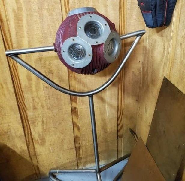 Steel rotating ball on a tripod with lens holes