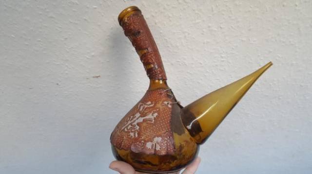 A traditional spouted glass vessel