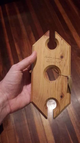 A carved wooden ring with slots