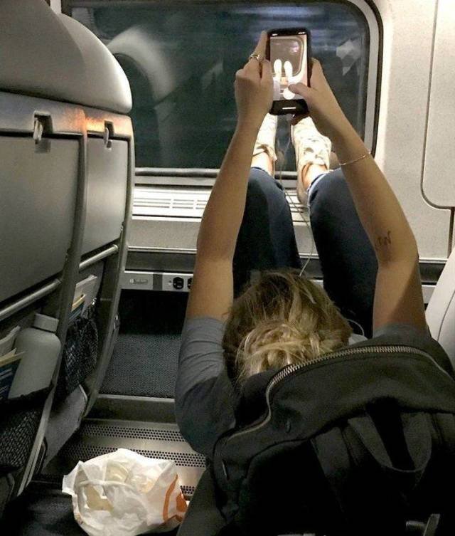 Feet propped up on a train window