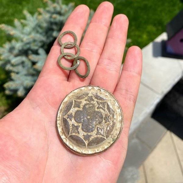 A four-leaf clover shaped metal object