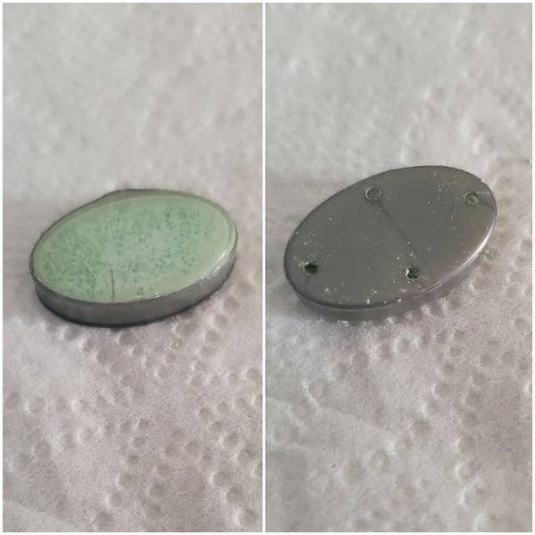 A small container with green powder inside