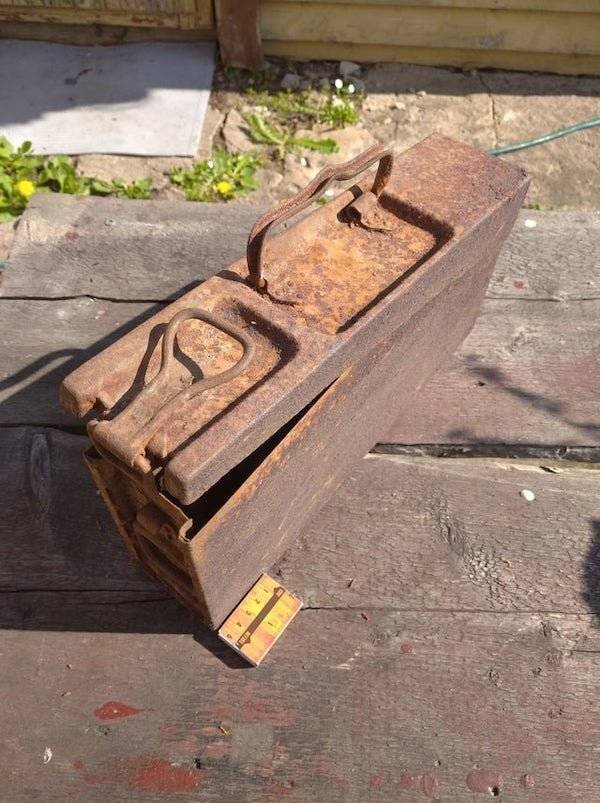 An old metal box next to a matchbox