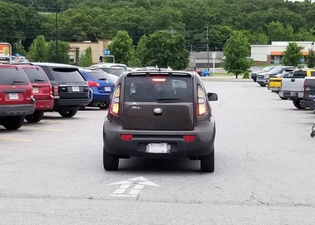 A car parked in the middle of a parking lane